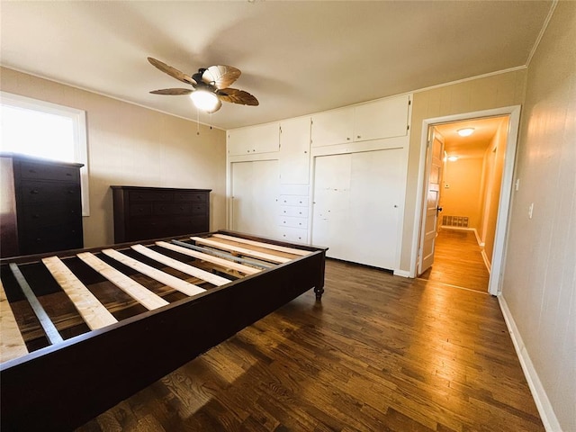 unfurnished bedroom with ceiling fan, a closet, and dark hardwood / wood-style floors