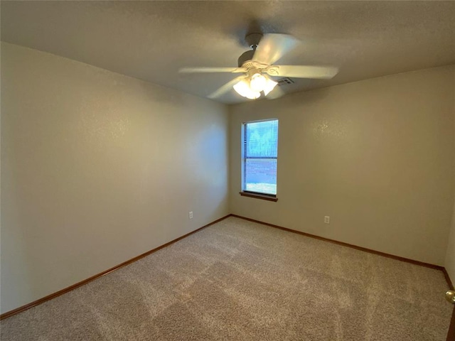 empty room with ceiling fan and carpet floors