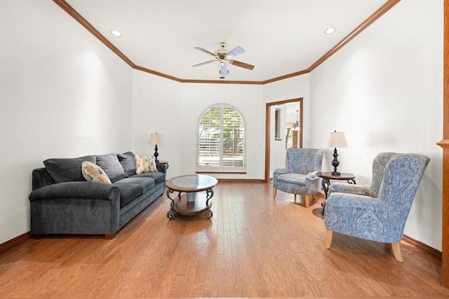 living room featuring baseboards, wood finished floors, and ornamental molding