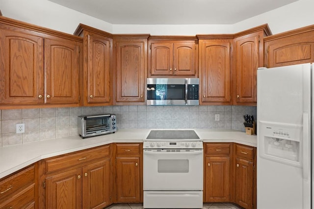 kitchen with white appliances, brown cabinets, and a toaster