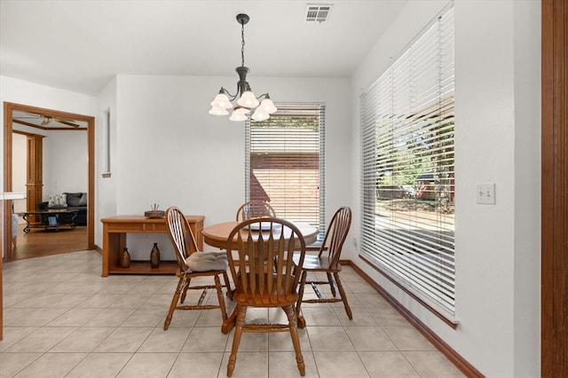 dining room featuring light tile patterned floors, visible vents, baseboards, and an inviting chandelier