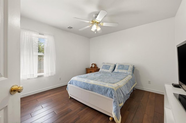 bedroom featuring a ceiling fan, baseboards, visible vents, and hardwood / wood-style floors