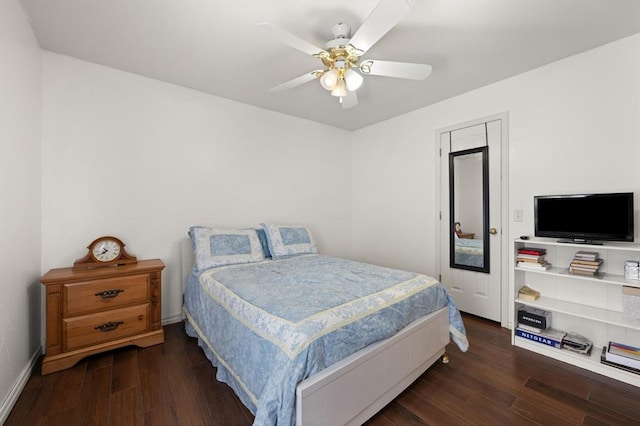 bedroom with a ceiling fan, baseboards, and wood finished floors