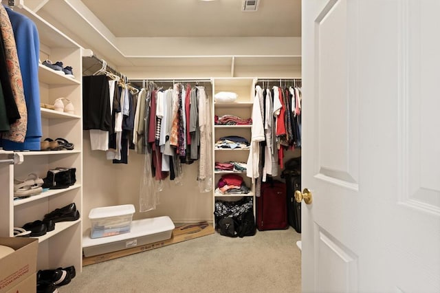 walk in closet with visible vents and carpet flooring