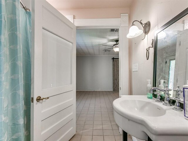 bathroom featuring ceiling fan, sink, and tile patterned floors