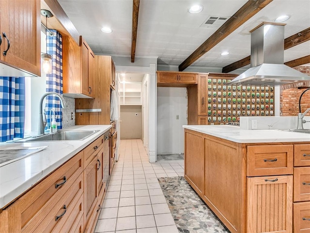 kitchen featuring backsplash, beam ceiling, sink, island exhaust hood, and light tile patterned flooring