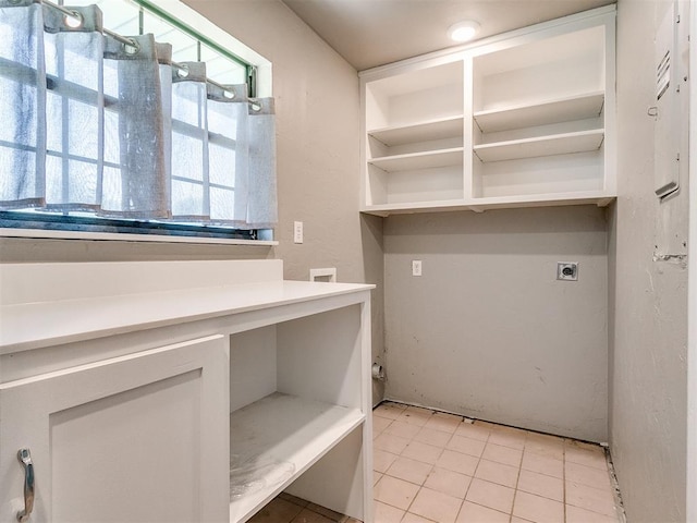 laundry room featuring light tile patterned floors and electric dryer hookup