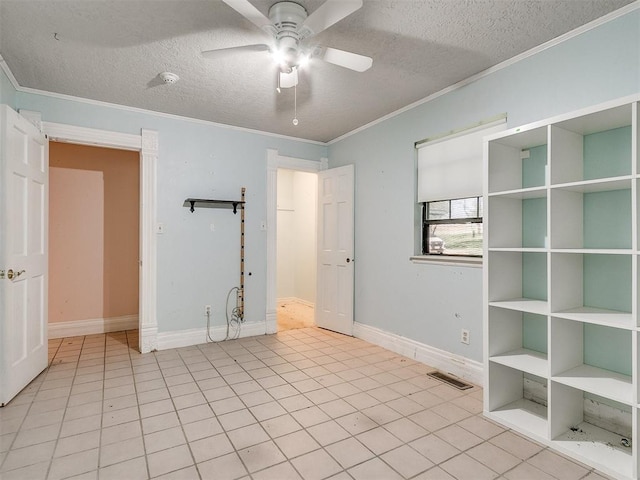 tiled spare room with ceiling fan, a textured ceiling, and ornamental molding