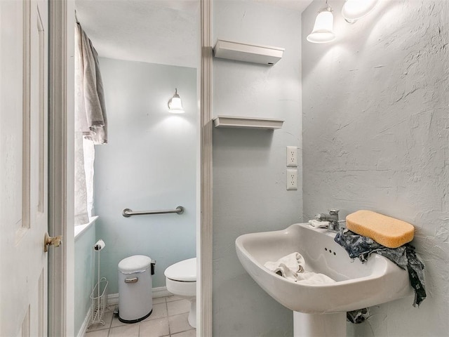 bathroom with sink, tile patterned floors, and toilet