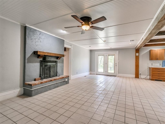 unfurnished living room with ceiling fan, light tile patterned flooring, and ornamental molding