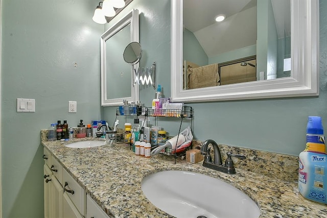 bathroom with vanity and lofted ceiling