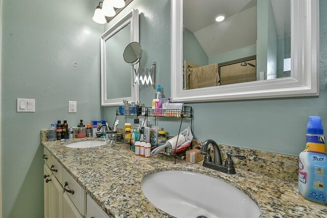 7301 Morning Song Dr, Oklahoma City, OK 73150 - full bathroom featuring double vanity, vaulted ceiling, and a shower