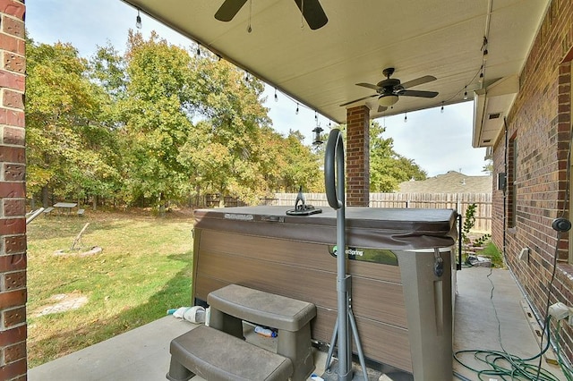 view of patio featuring ceiling fan and a hot tub