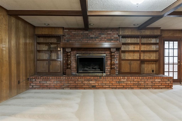 unfurnished living room with beam ceiling, light carpet, and wooden walls