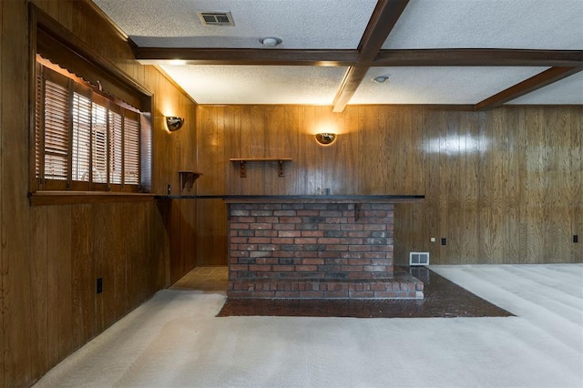 bar with beam ceiling, a textured ceiling, light colored carpet, and wood walls