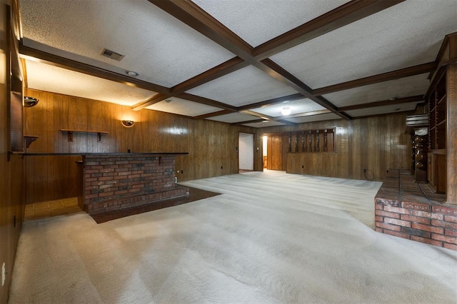 basement featuring bar area, carpet floors, and wood walls