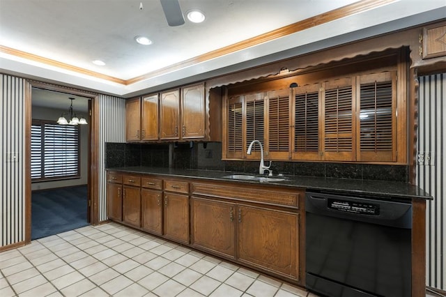 kitchen featuring pendant lighting, dishwasher, sink, tasteful backsplash, and light tile patterned flooring