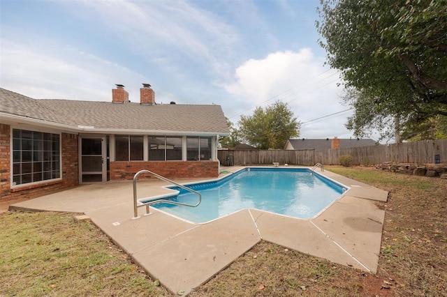 view of pool featuring a sunroom and a patio