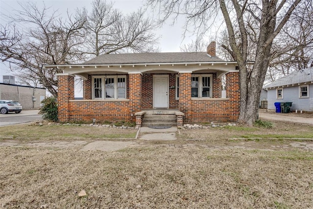 bungalow-style home featuring a front yard