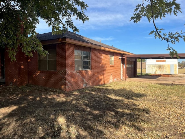 back of house with a yard and a carport