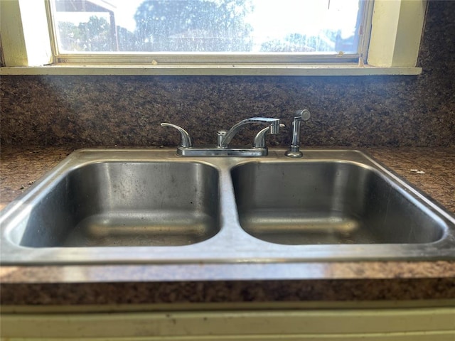 details featuring sink and tasteful backsplash