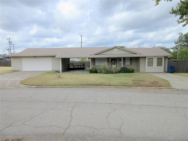 ranch-style home with a carport, a garage, and a front lawn