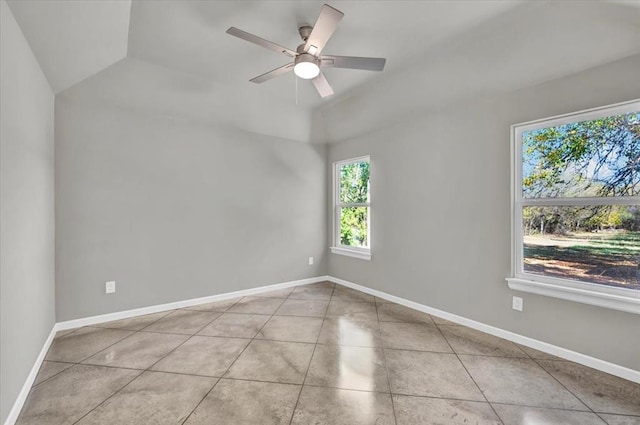 tiled spare room featuring ceiling fan and vaulted ceiling