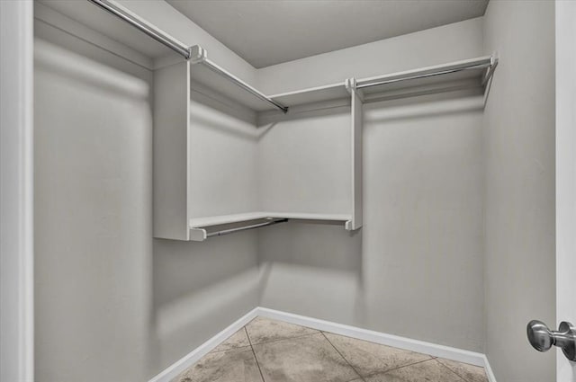 spacious closet featuring light tile patterned floors