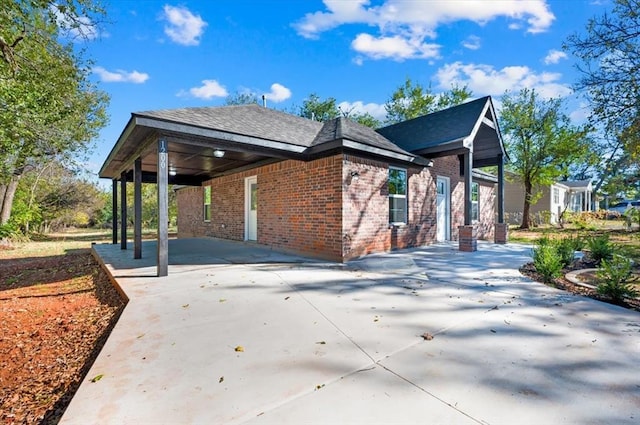 1200 N Lloyd Dr, Oklahoma City, OK 73130 - view of home's exterior featuring brick siding, driveway, and a carport