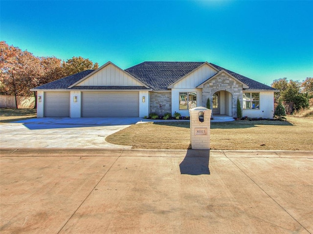 ranch-style home with a front yard and a garage