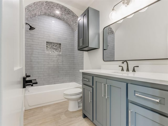 full bathroom featuring vanity, toilet, and tiled shower / bath combo