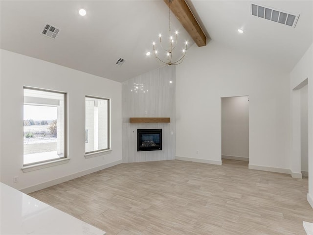 unfurnished living room featuring light wood-type flooring, an inviting chandelier, high vaulted ceiling, beamed ceiling, and a fireplace