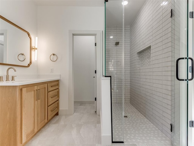 bathroom featuring vanity and a shower with door