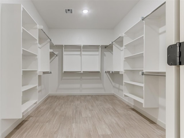 spacious closet featuring light hardwood / wood-style flooring