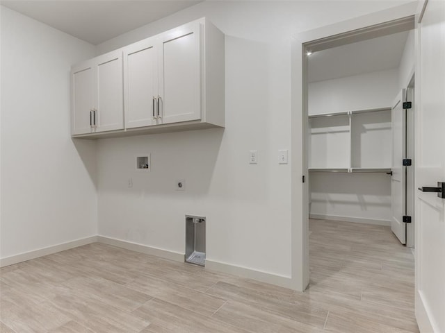 washroom with cabinets, washer hookup, light hardwood / wood-style flooring, and hookup for an electric dryer