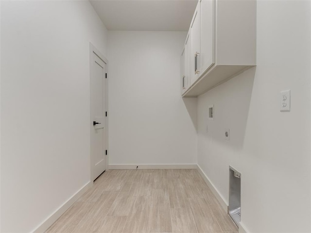 laundry area with electric dryer hookup, light hardwood / wood-style floors, cabinets, and hookup for a washing machine