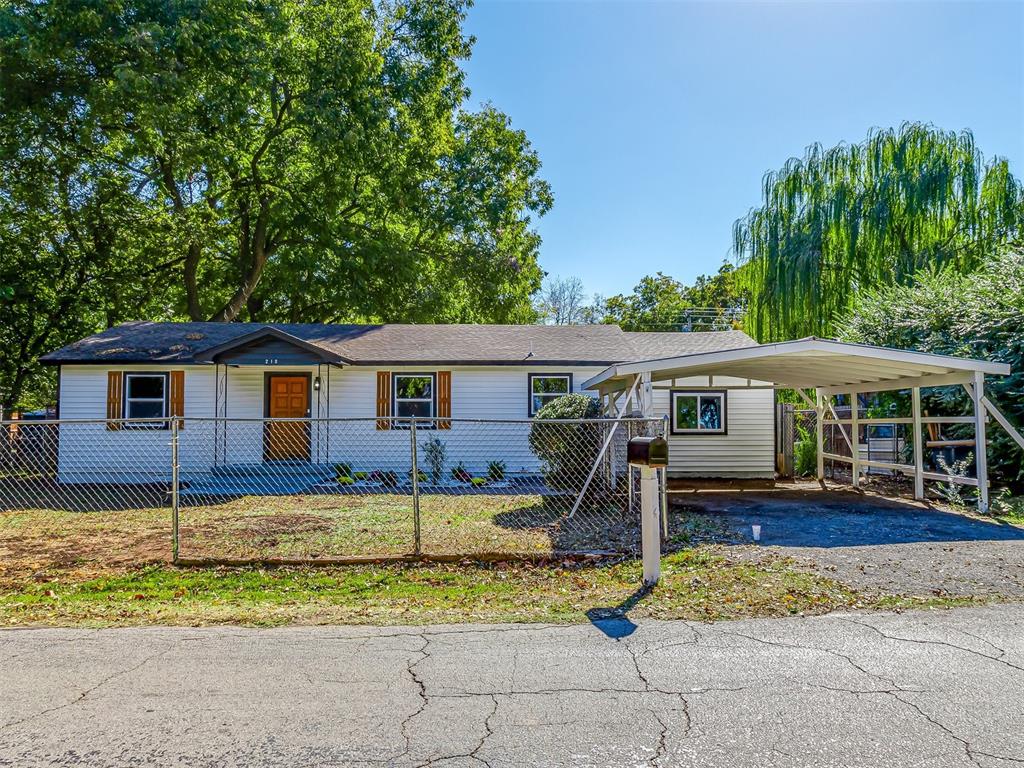 ranch-style home featuring a carport