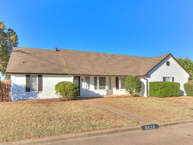 ranch-style home featuring a front lawn