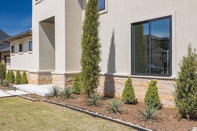 view of side of home with a lawn