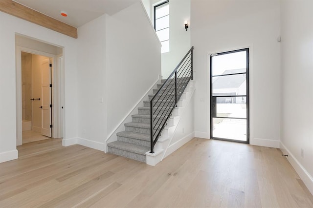 staircase with hardwood / wood-style flooring