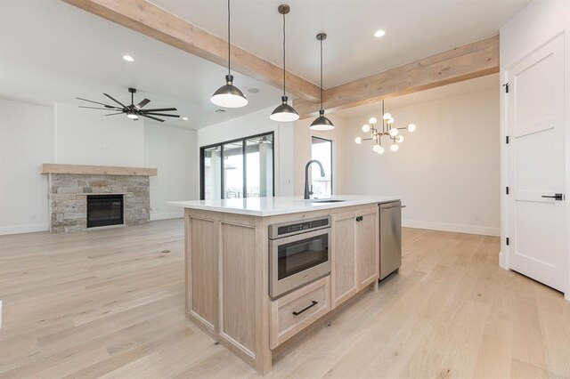 2009 Wiregrass Dr, Edmond, OK 73025 - kitchen with beam ceiling, a sink, a chandelier, light wood finished floors, and recessed lighting