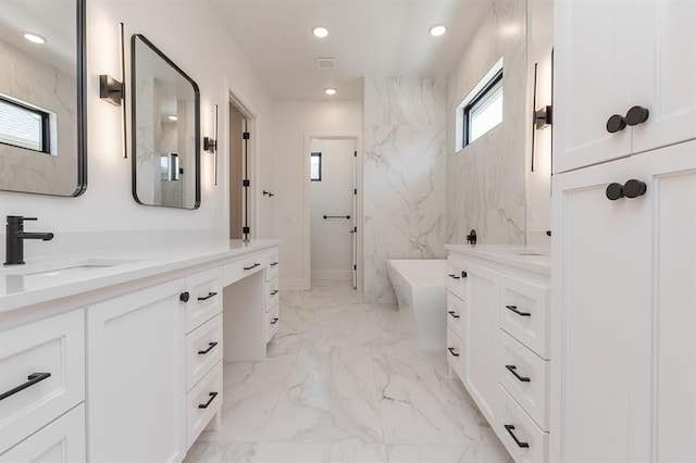 2009 Wiregrass Dr, Edmond, OK 73025 - bathroom with vanity, a soaking tub, marble finish floors, and recessed lighting