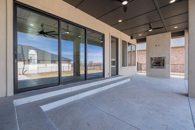2009 Wiregrass Dr, Edmond, OK 73025 - view of patio with an outdoor fireplace and ceiling fan