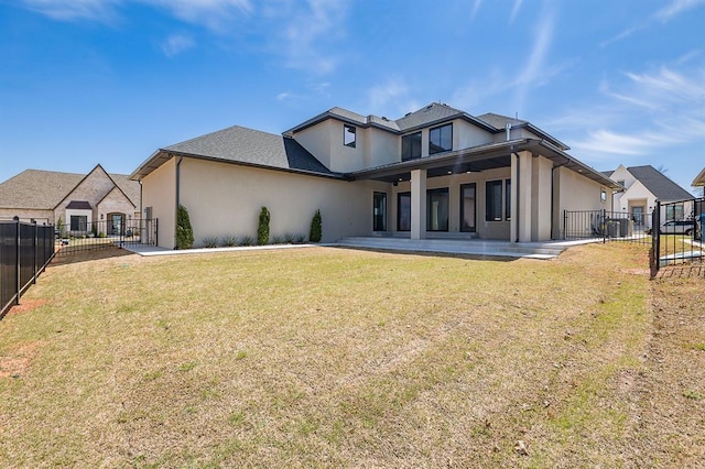 rear view of house featuring a lawn, central AC, and a patio