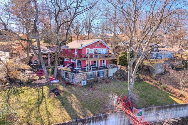 rear view of property with a yard and a deck