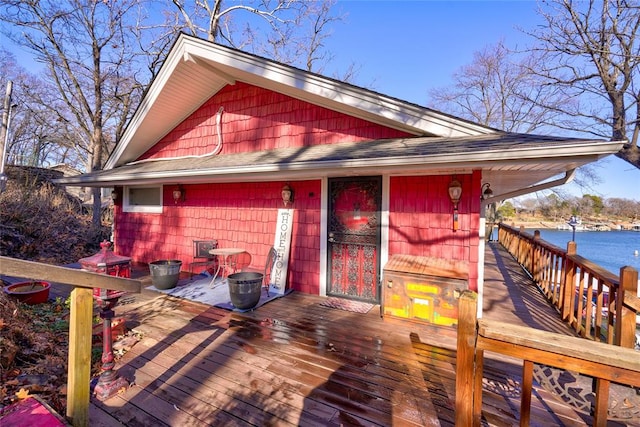 exterior space featuring a deck with water view