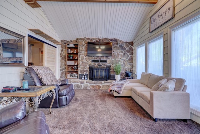 living room featuring carpet flooring, lofted ceiling with beams, a stone fireplace, and wooden walls