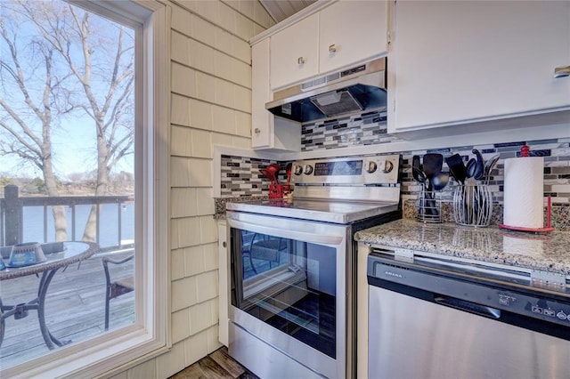 kitchen with white cabinetry, light stone counters, backsplash, a water view, and appliances with stainless steel finishes