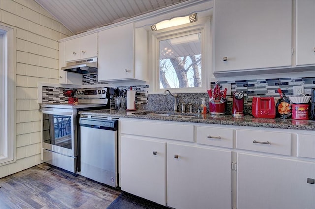 kitchen with lofted ceiling, dark wood-type flooring, white cabinets, sink, and stainless steel appliances