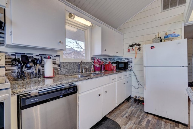 kitchen featuring white cabinetry, sink, stainless steel dishwasher, dark hardwood / wood-style floors, and white fridge